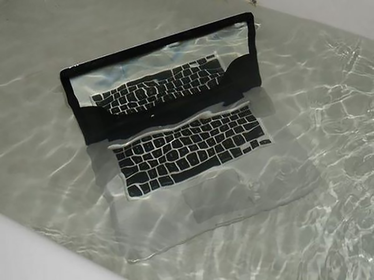 Mac laptop half-submerged in a bath.